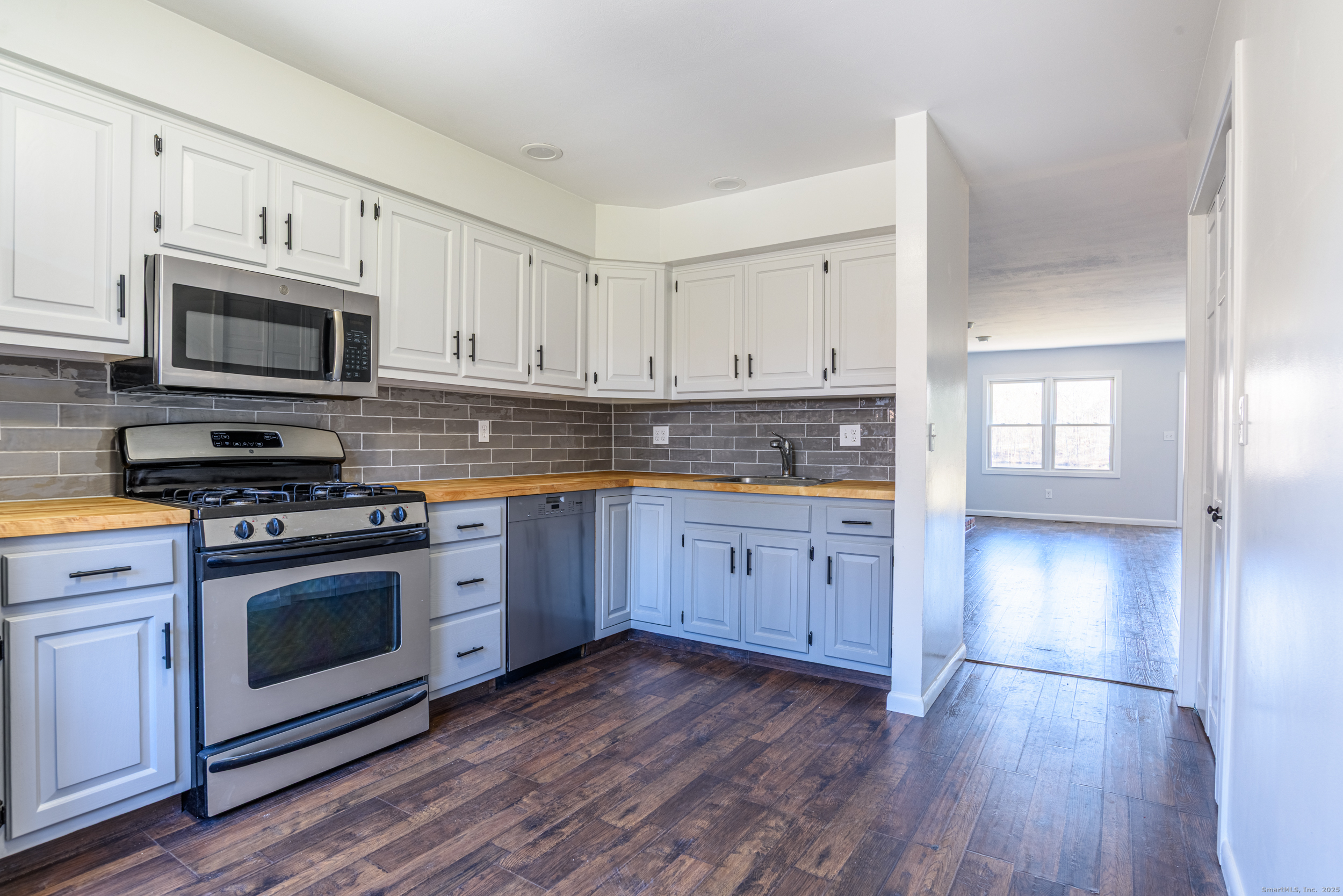 84 Stillmeadow Circle, Unit 84 Monroe, CT 06468 - Photo 5 of 20 a kitchen with stainless steel appliances granite countertop a stove a sink and a microwave