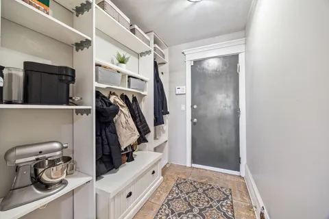 a view of a kitchen with furniture and wooden floor