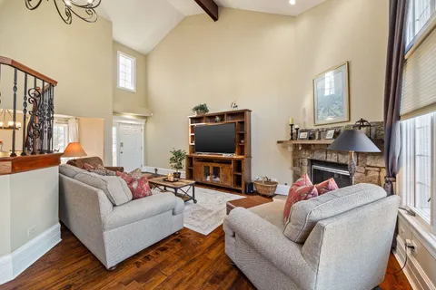 a large kitchen with stainless steel appliances granite countertop a large counter top a stove a sink and a refrigerator