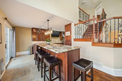 a kitchen with stainless steel appliances granite countertop wooden cabinets and a stove top oven