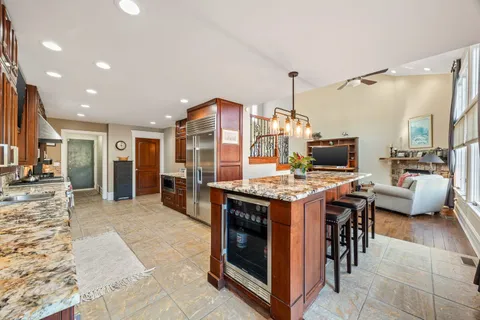 a kitchen with stainless steel appliances granite countertop a stove and a sink