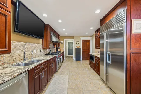 a kitchen with stainless steel appliances granite countertop a stove and a sink