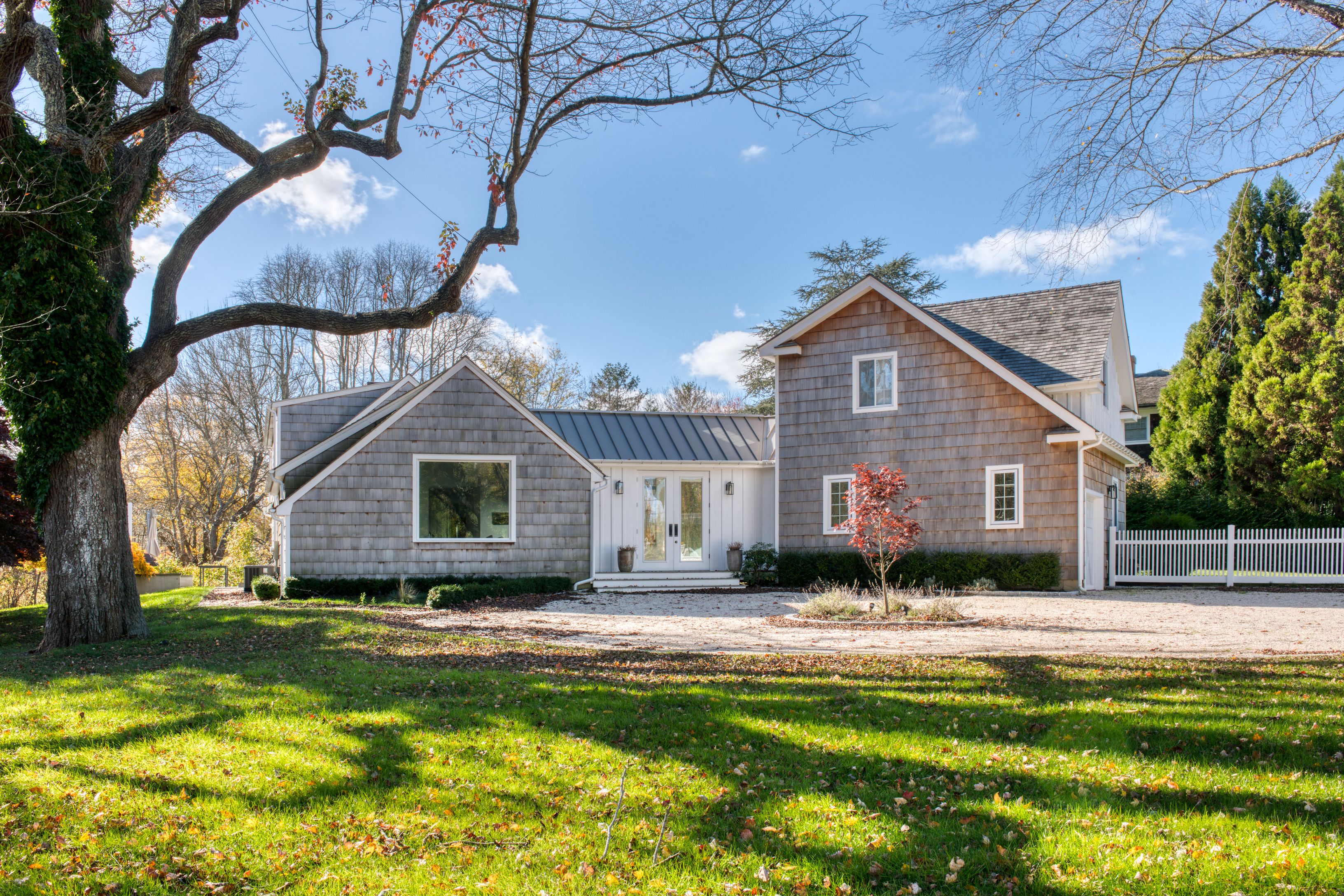 225 Oak Street Bridgehampton, NY 11932 - Photo 1 of 26 a front view of a house with a yard