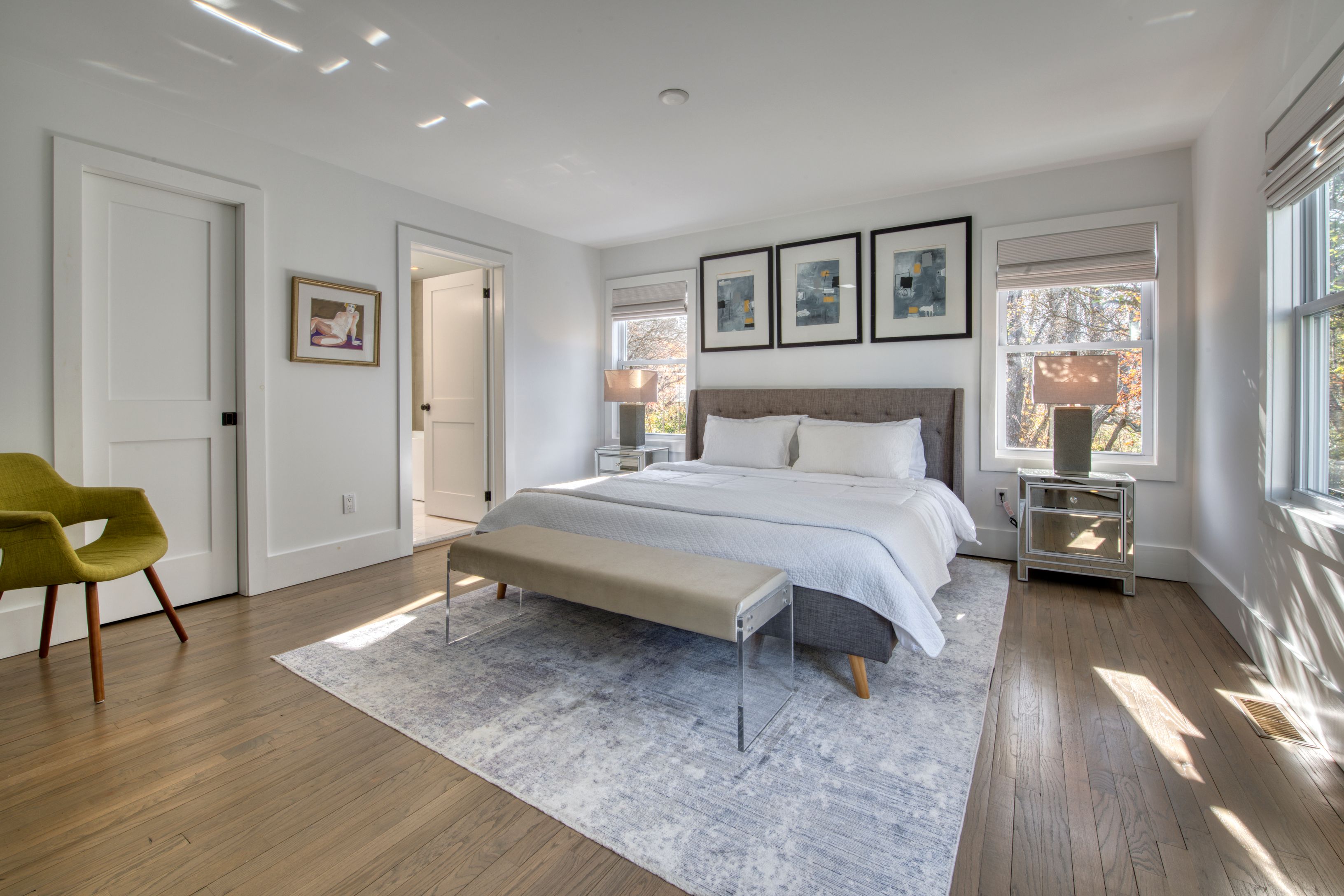 225 Oak Street Bridgehampton, NY 11932 - Photo 11 of 26 a bedroom with a bed a table and painting on the wall