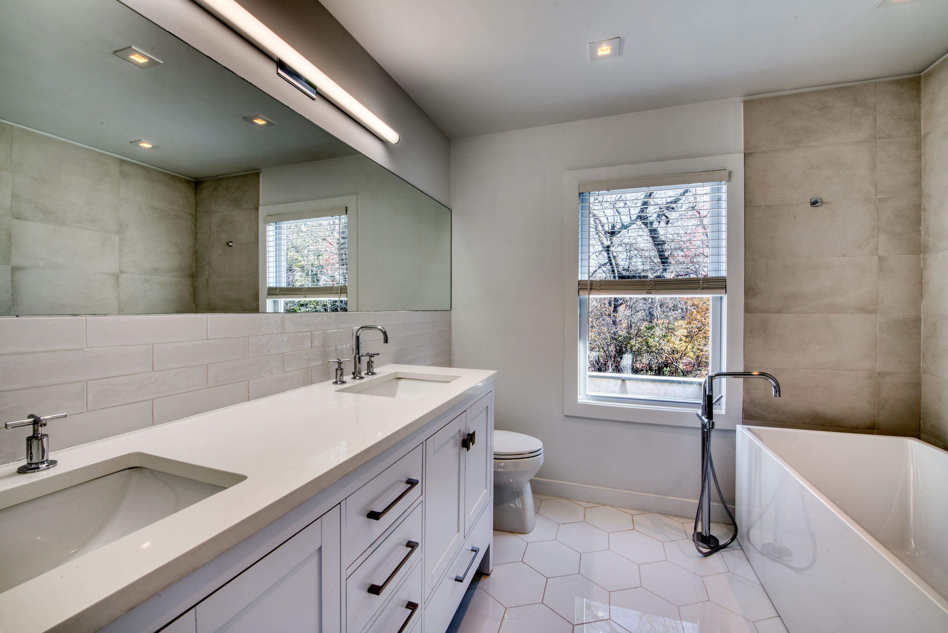 225 Oak Street Bridgehampton, NY 11932 - Photo 13 of 26 a bathroom with a sink a toilet and bathtub