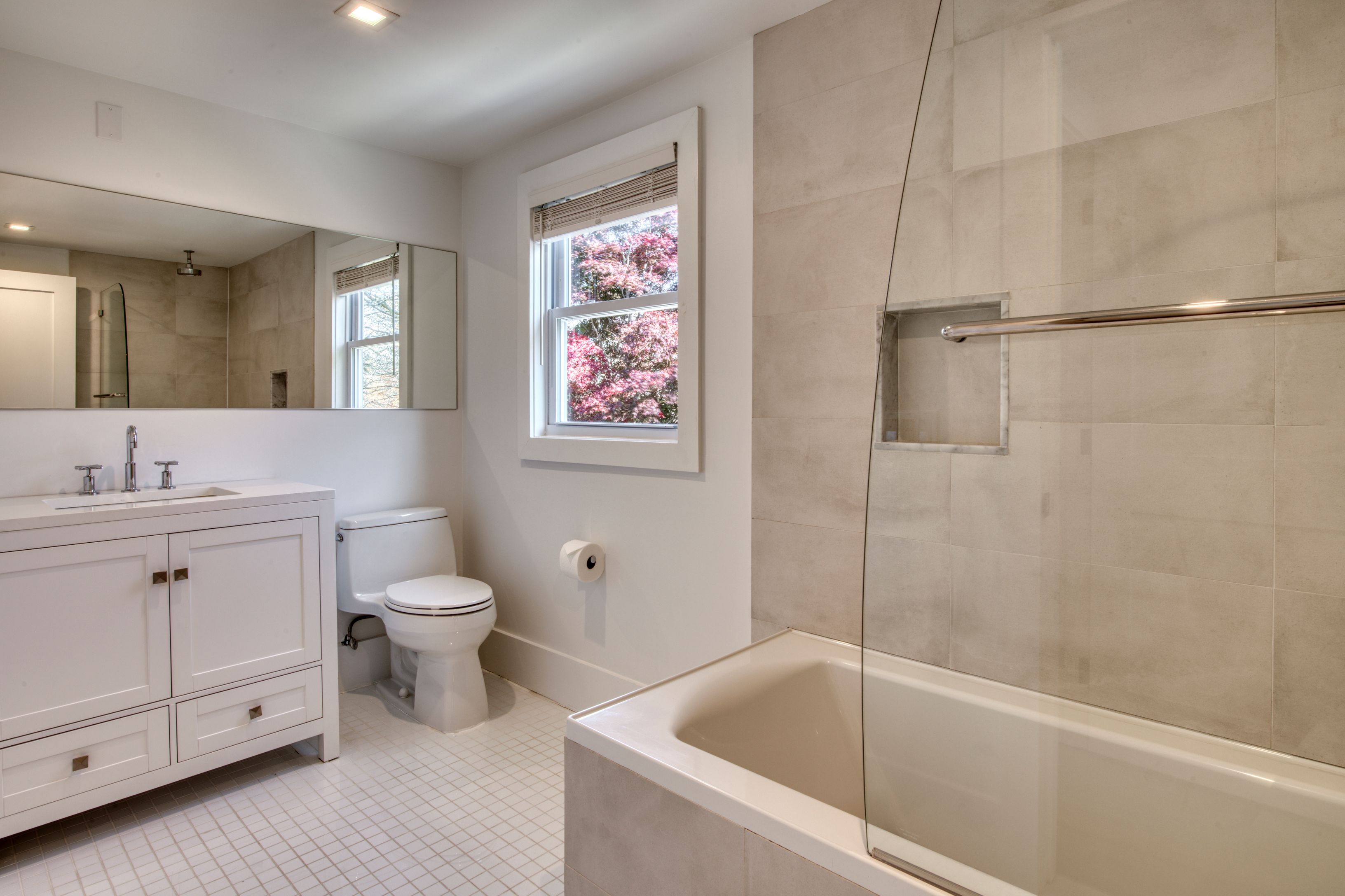 225 Oak Street Bridgehampton, NY 11932 - Photo 16 of 26 a bathroom with a bathtub sink vanity and toilet