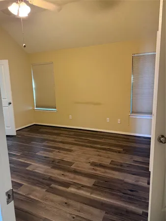 a bedroom with a bed and a night stand