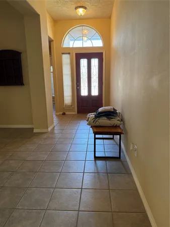 a hallway with a window and a rug
