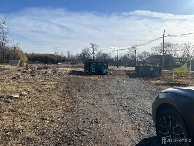 a view of a dry yard with wooden fence