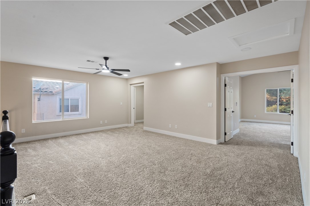 1662 Ravanusa Drive Henderson, NV 89052 - Photo 18 of 74 A spacious secondary living area with a ceiling fan, plush carpeting, and generous natural light.