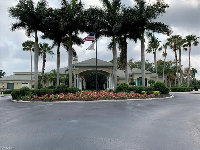 a front view of multi story residential apartment building with yard and green space