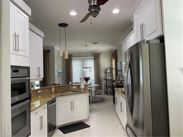 a kitchen with stainless steel appliances a refrigerator sink and microwave