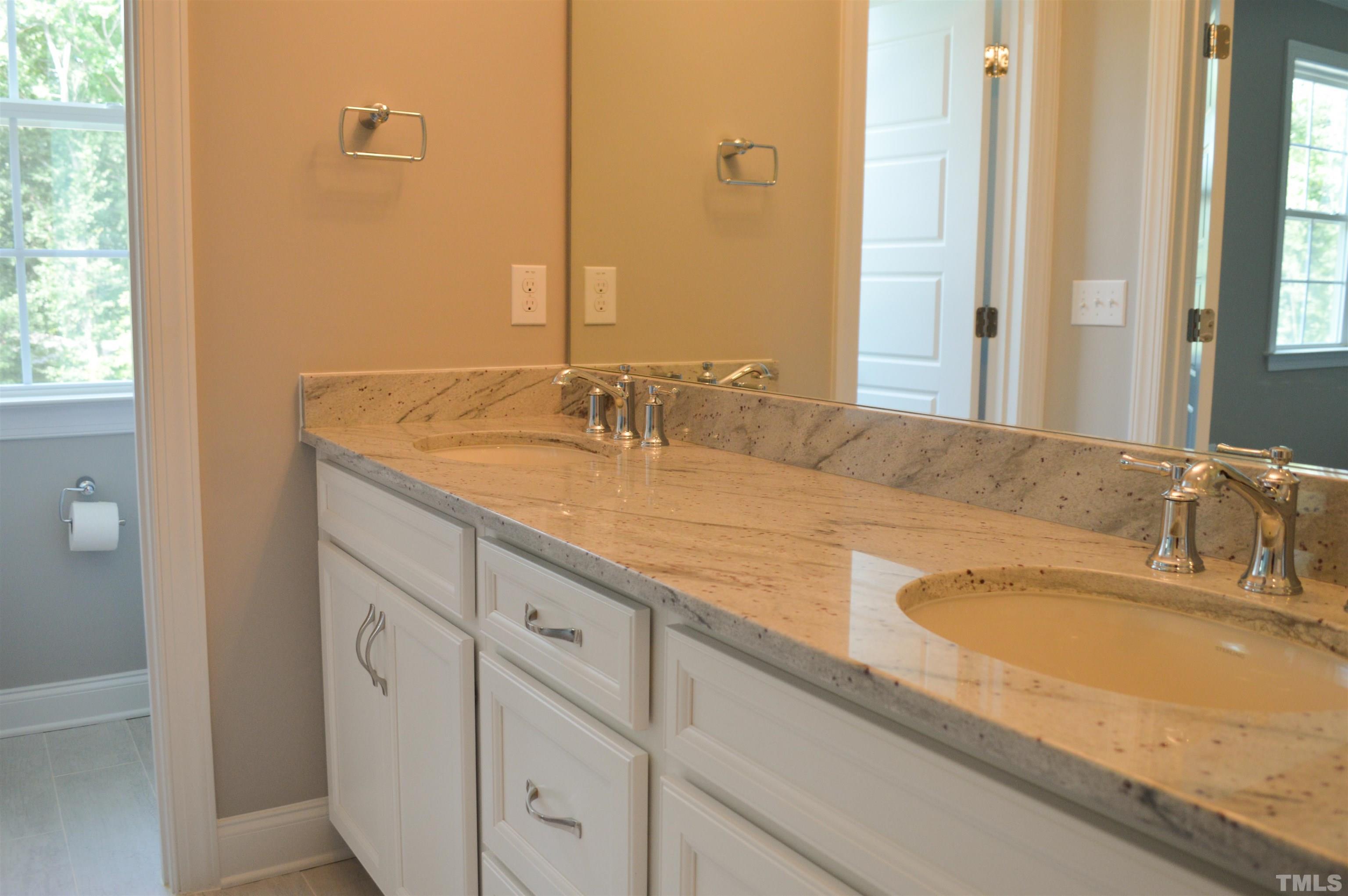 849 Wake Towne Drive Raleigh, NC 27609 - Photo 12 of 17 a bathroom with double sink and a mirror