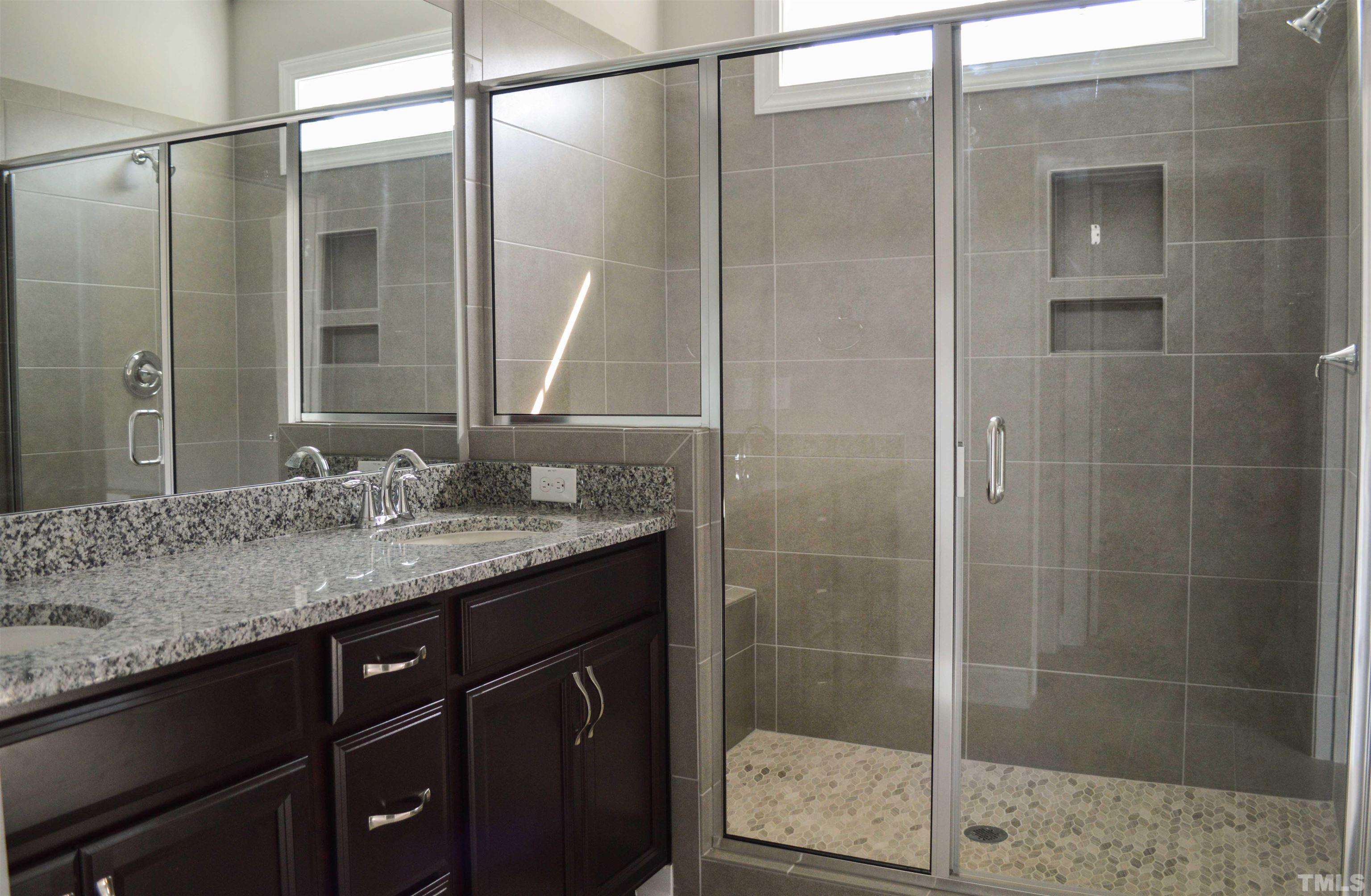 849 Wake Towne Drive Raleigh, NC 27609 - Photo 14 of 17 a bathroom with a granite countertop shower sink and mirror