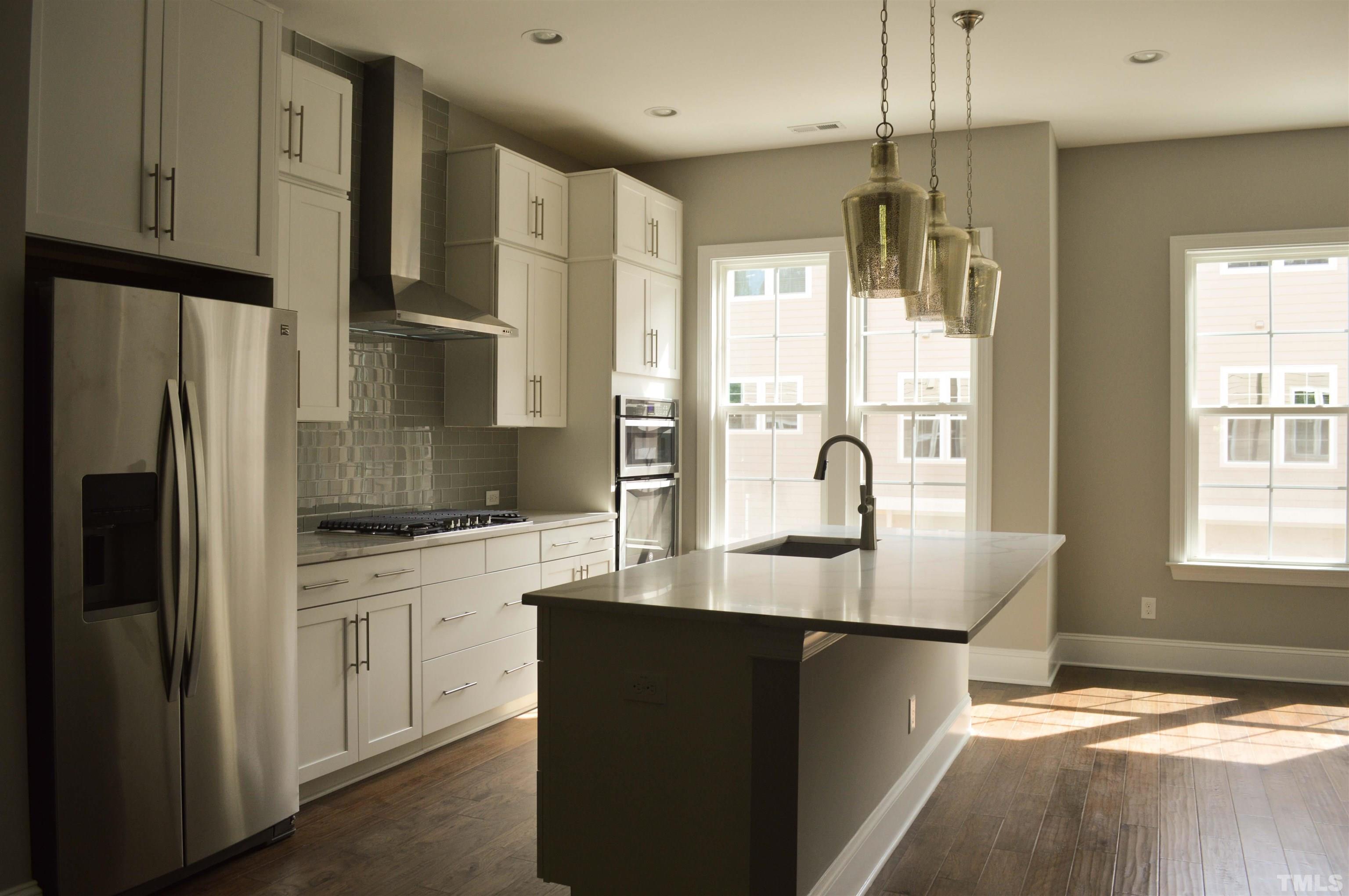 849 Wake Towne Drive Raleigh, NC 27609 - Photo 6 of 17 a kitchen with stainless steel appliances granite countertop a refrigerator and a sink