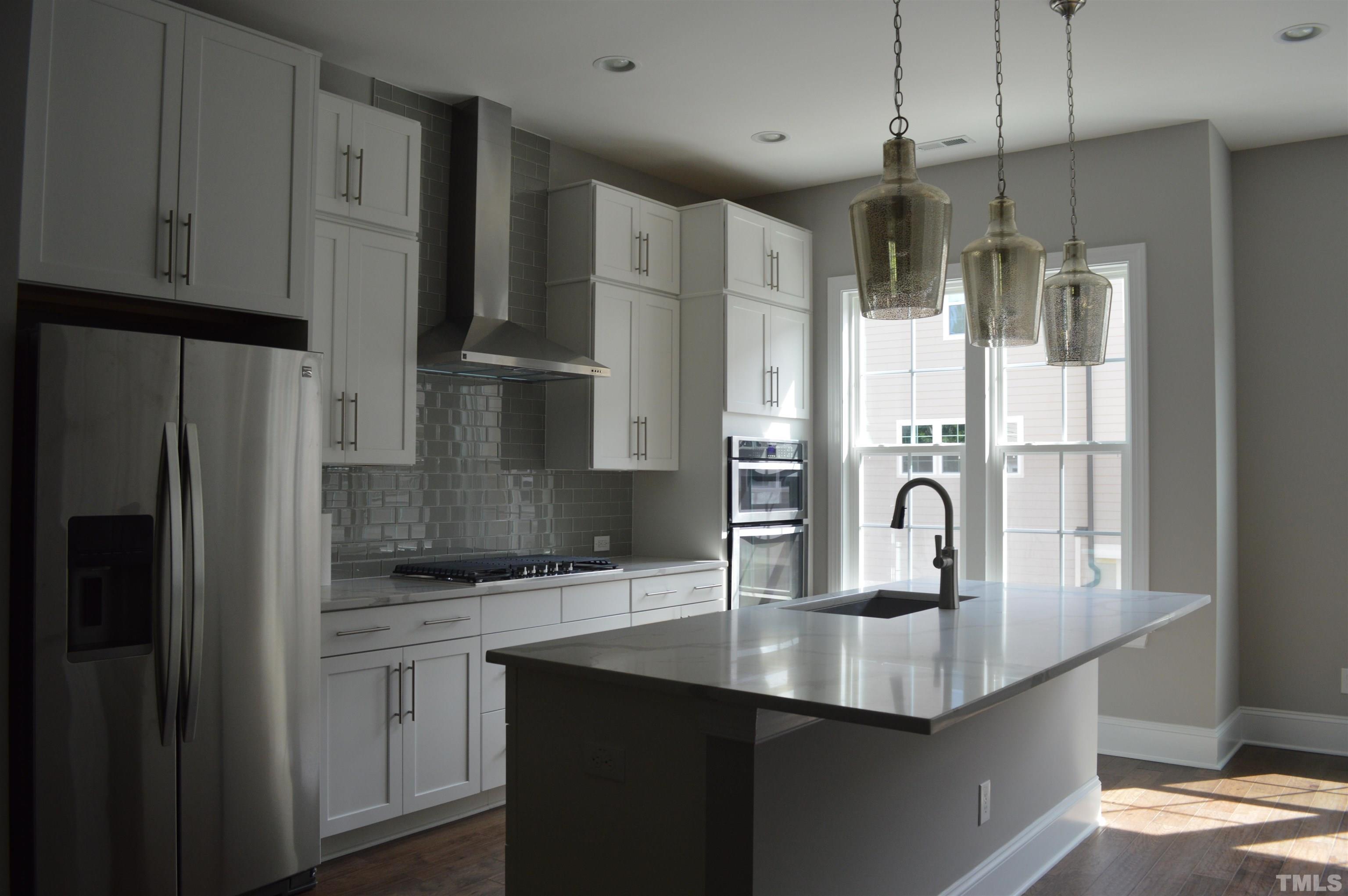 849 Wake Towne Drive Raleigh, NC 27609 - Photo 7 of 17 a kitchen with stainless steel appliances a refrigerator and cabinets