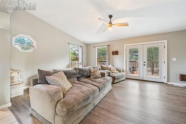 a kitchen with white cabinets stainless steel appliances and a window