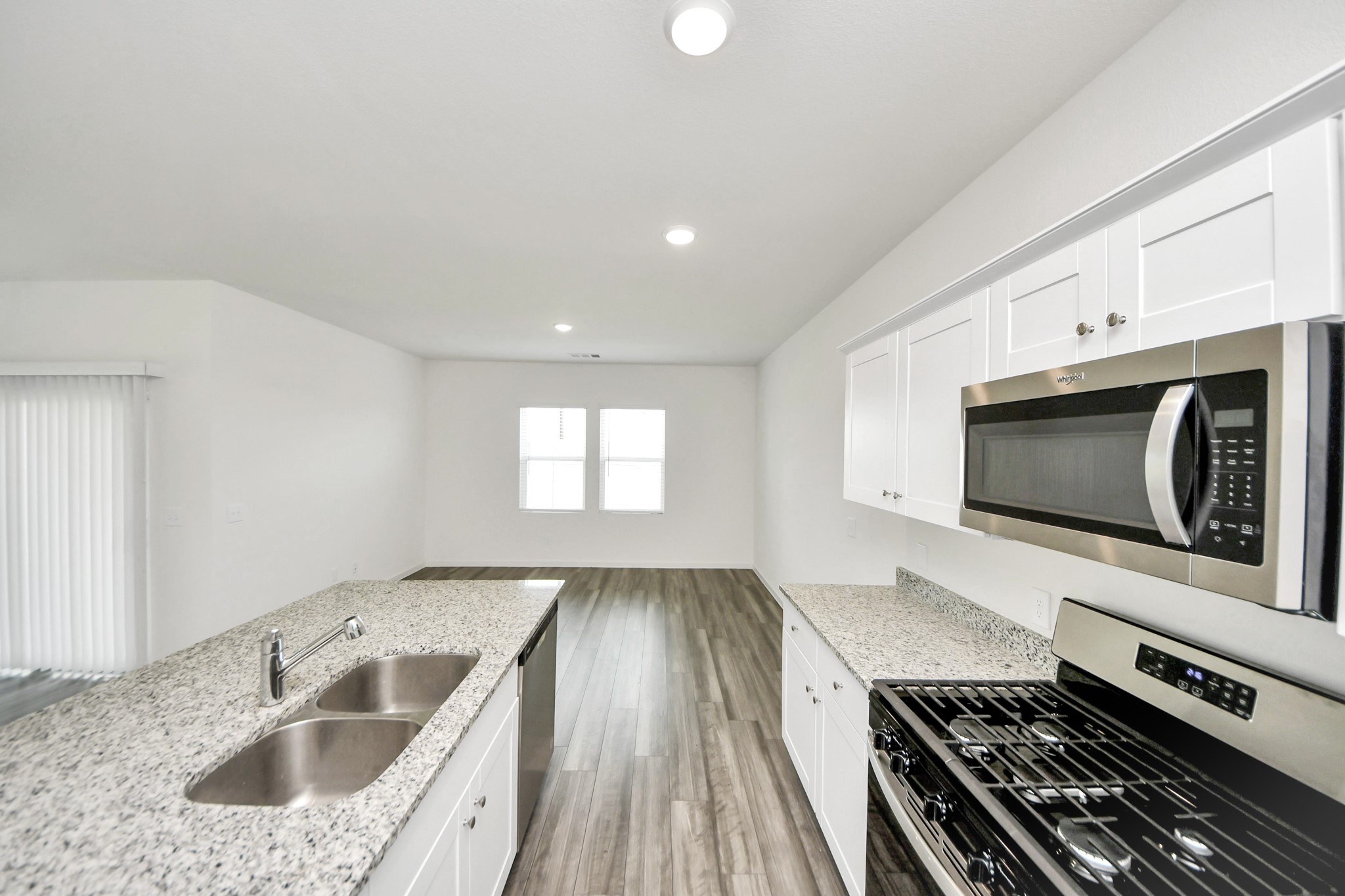 10303 Rose Mar Drive, Unit B Rosharon, TX 77583 - Photo 12 of 49 a kitchen with a sink and a stove top oven