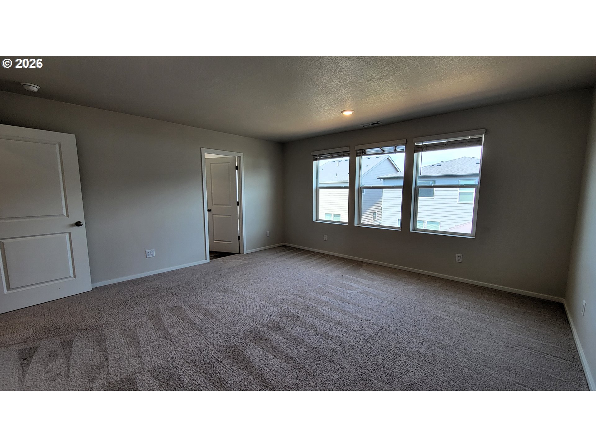 2960 V Street Springfield, OR 97477 - Photo 11 of 27 a open hall with a floor to ceiling window and wooden floor