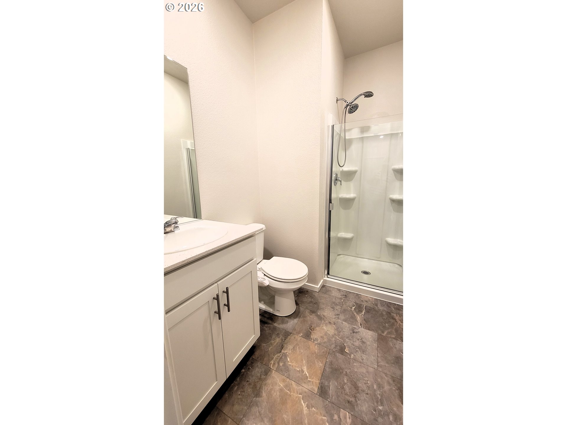 2960 V Street Springfield, OR 97477 - Photo 23 of 27 a bathroom with a granite countertop toilet a sink and a mirror