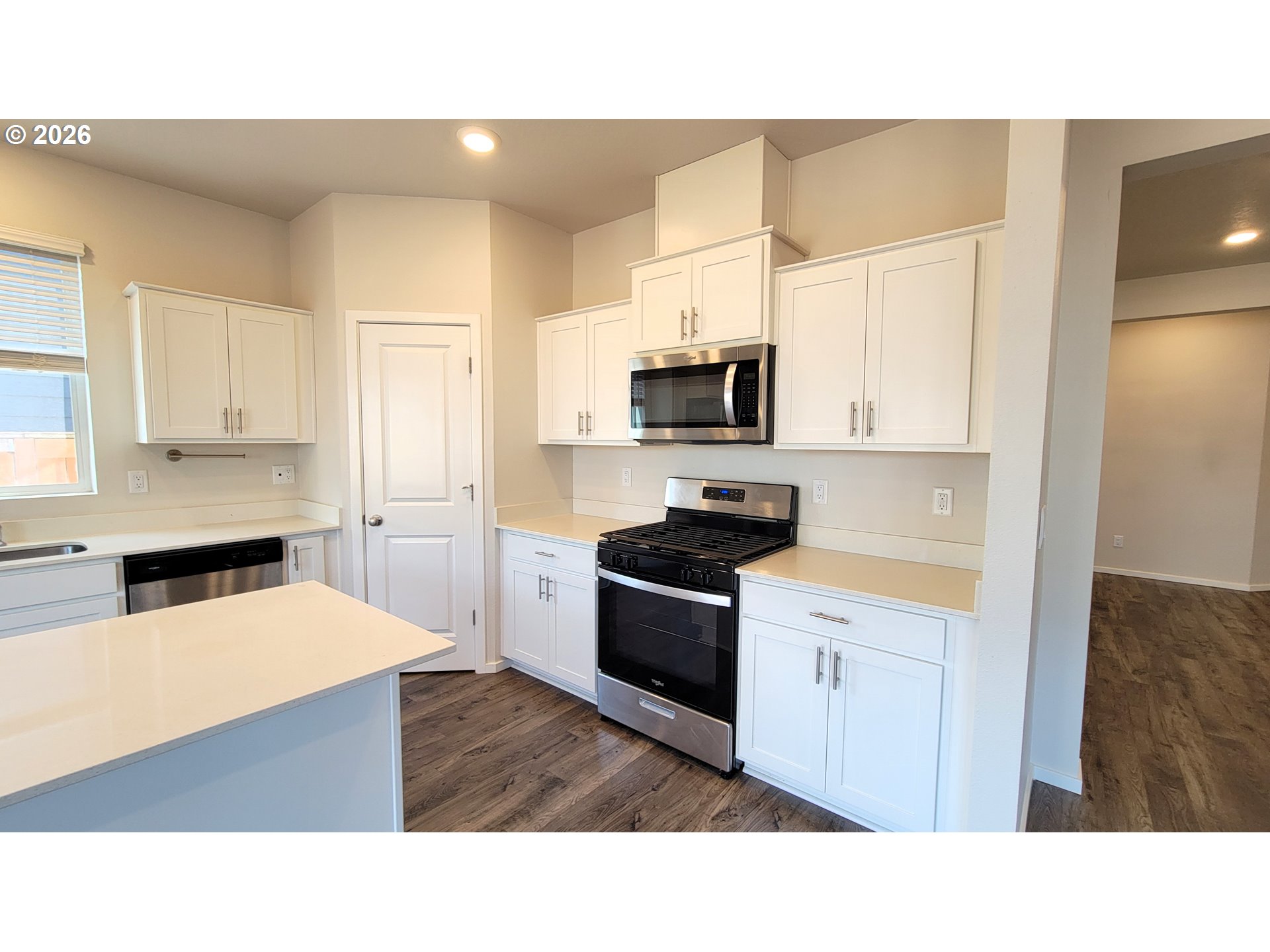 2960 V Street Springfield, OR 97477 - Photo 5 of 27 a kitchen with kitchen island a sink stainless steel appliances and cabinets