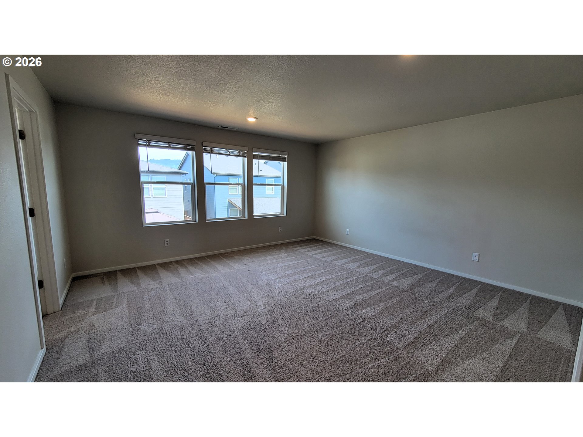 2960 V Street Springfield, OR 97477 - Photo 10 of 27 a open hall with a floor to ceiling window and a wooden floor