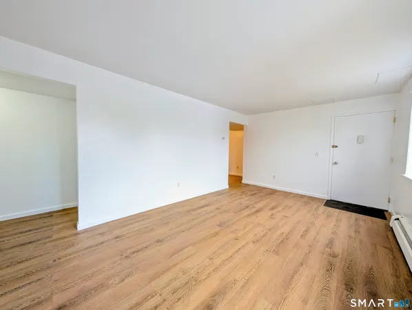 a white toilet sitting next to a shower curtain