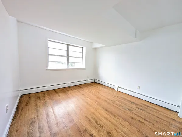 a view of room with wooden floor