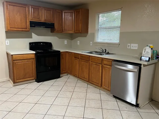 a kitchen with granite countertop cabinets and steel appliances