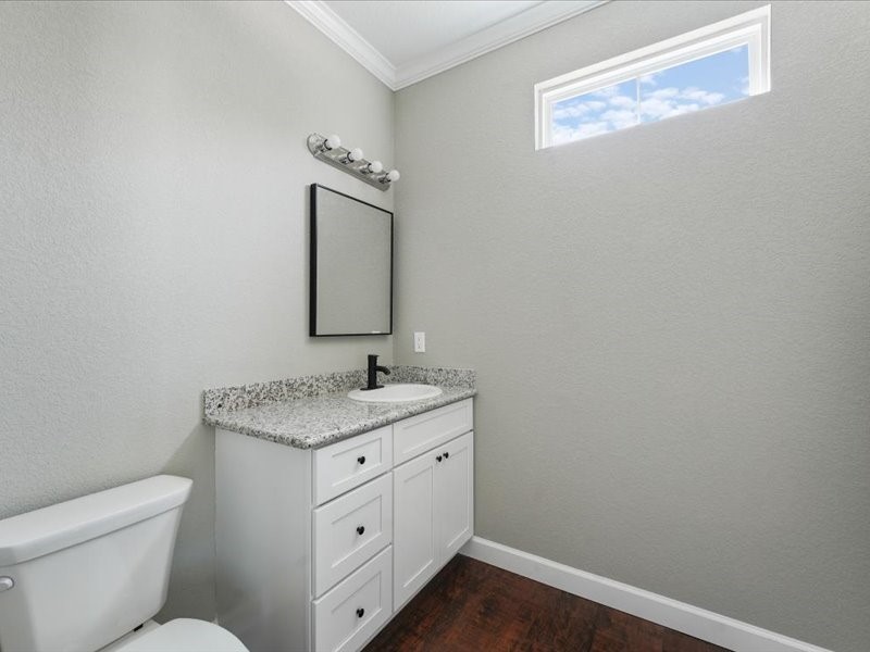 21500 Ruth Drive New Caney, TX 77357 - Photo 7 of 9 a bathroom with a granite countertop toilet sink and mirror