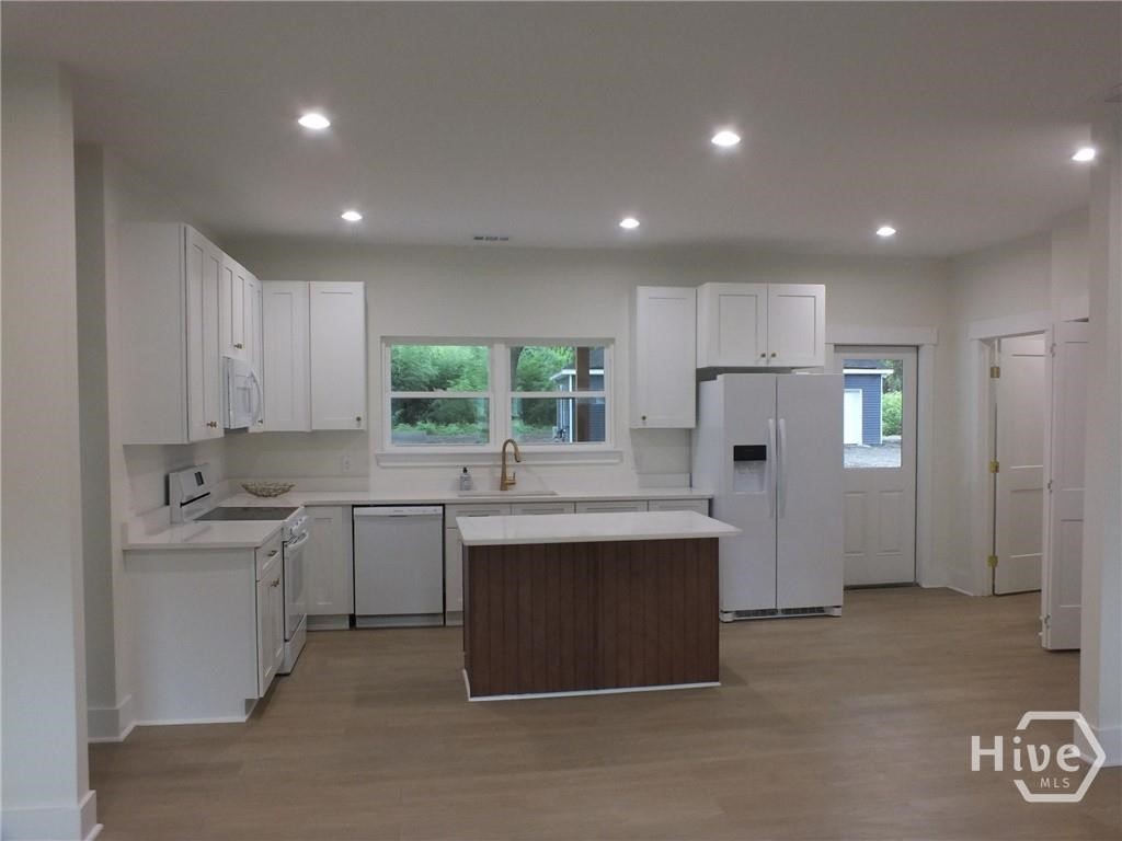 309 Honey Ridge Road Guyton, GA 31312 - Photo 4 of 14 Kitchen with Quartz Countertops and brushed gold h