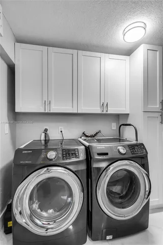 a utility room with sink dryer and washer