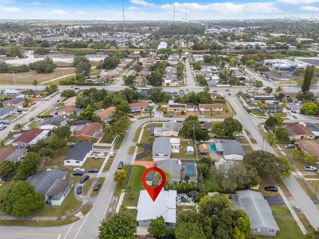 an aerial view of residential houses with city view