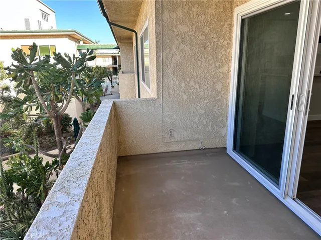 a view of empty room with wooden floor and window