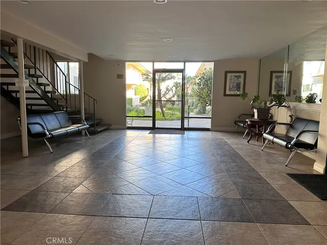 a lobby with furniture and floor to ceiling window