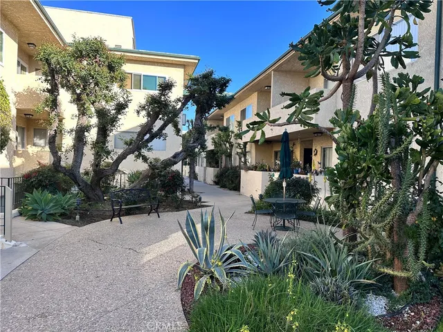 a view of a patio with table and chairs and potted plants