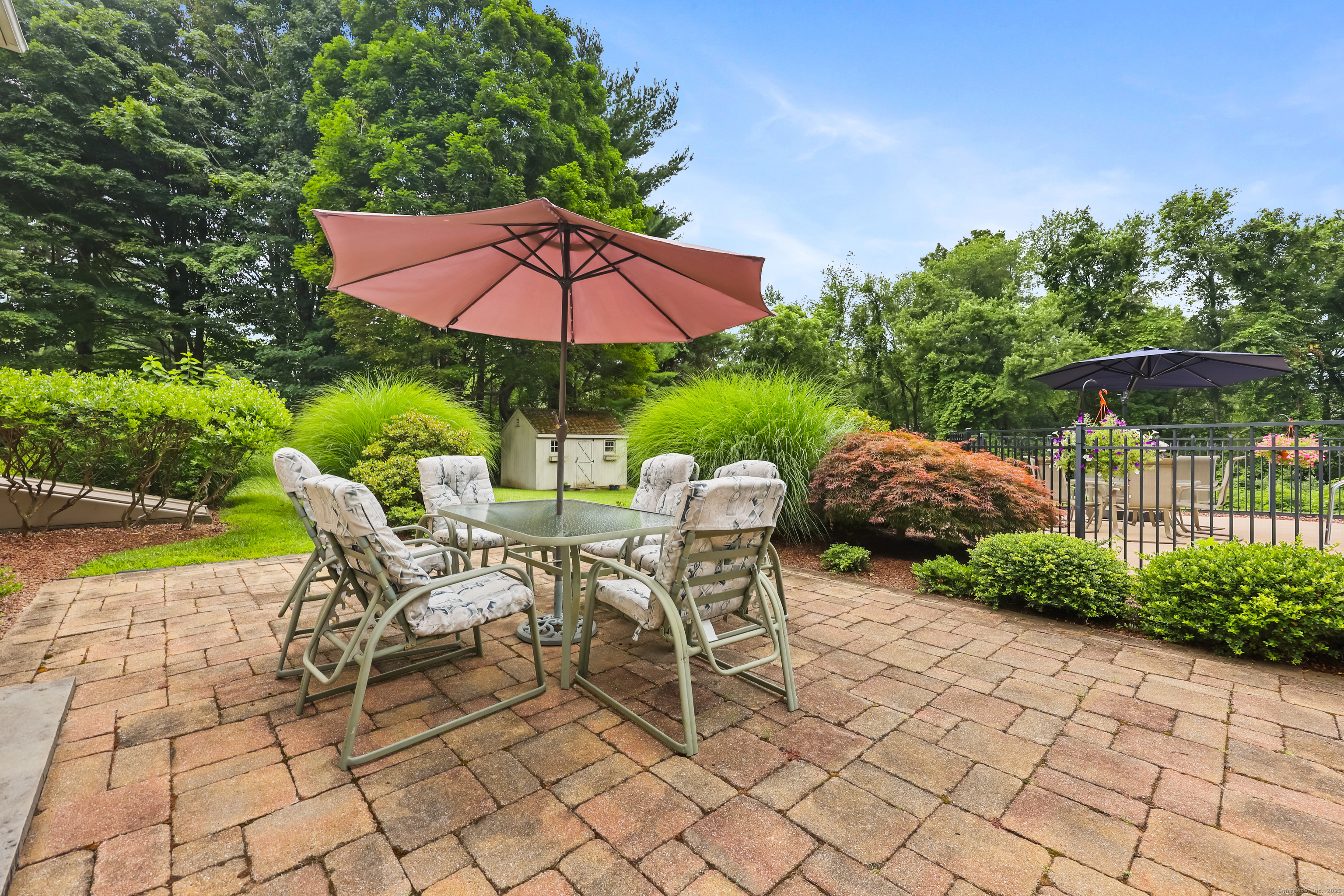 28 Sunnyview Drive Redding, CT 06896 - Photo 30 of 38 a view of a patio with a table and chairs under an umbrella