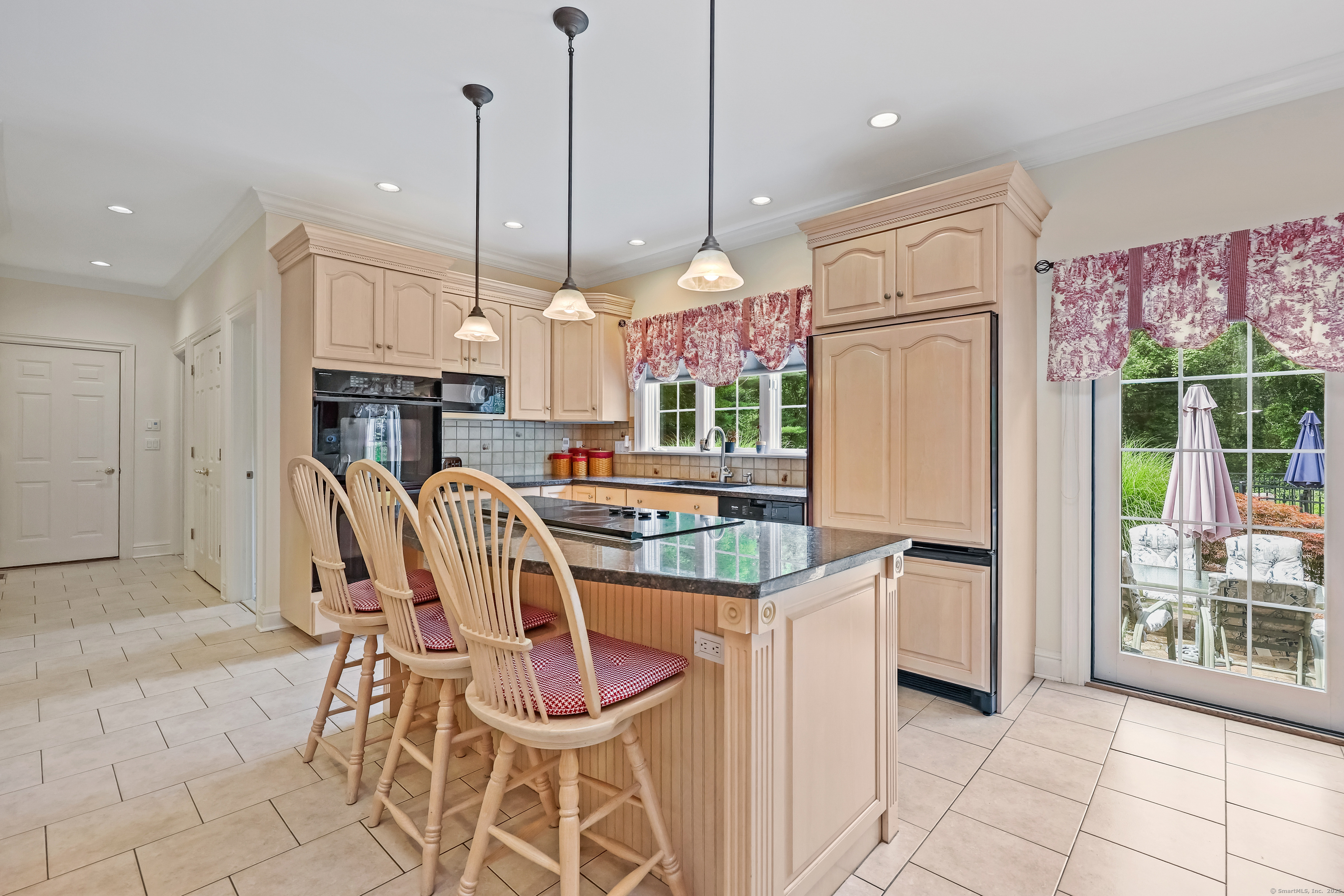 28 Sunnyview Drive Redding, CT 06896 - Photo 8 of 38 a kitchen with stainless steel appliances kitchen island granite countertop a refrigerator a stove a kitchen island a dining table and chairs