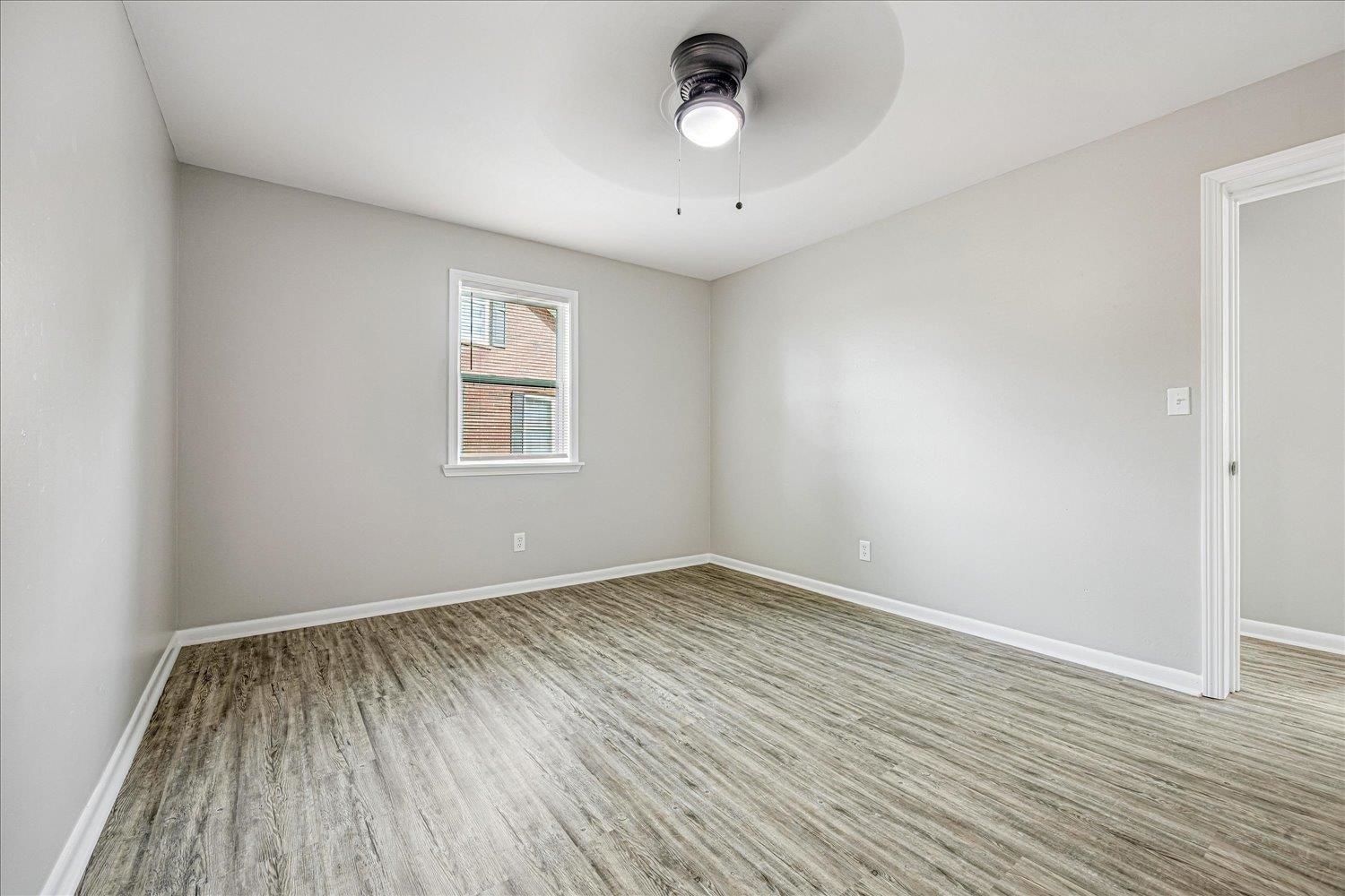179 Harris Cove Collierville, TN 38017 - Photo 13 of 25 Empty room with light wood-type flooring and ceiling fan