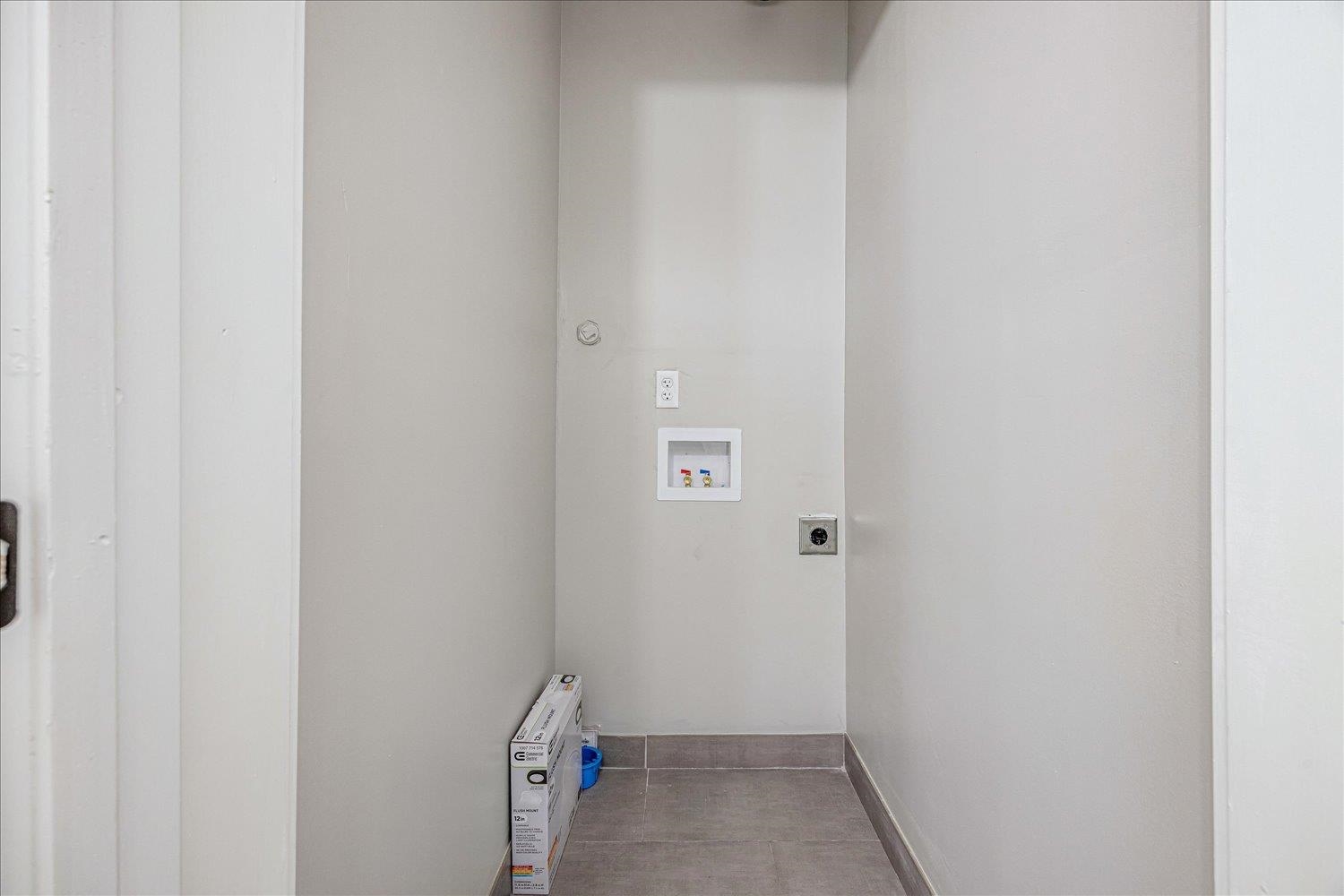 179 Harris Cove Collierville, TN 38017 - Photo 14 of 25 Laundry area with hookup for a washing machine, electric dryer hookup, and light tile patterned flooring