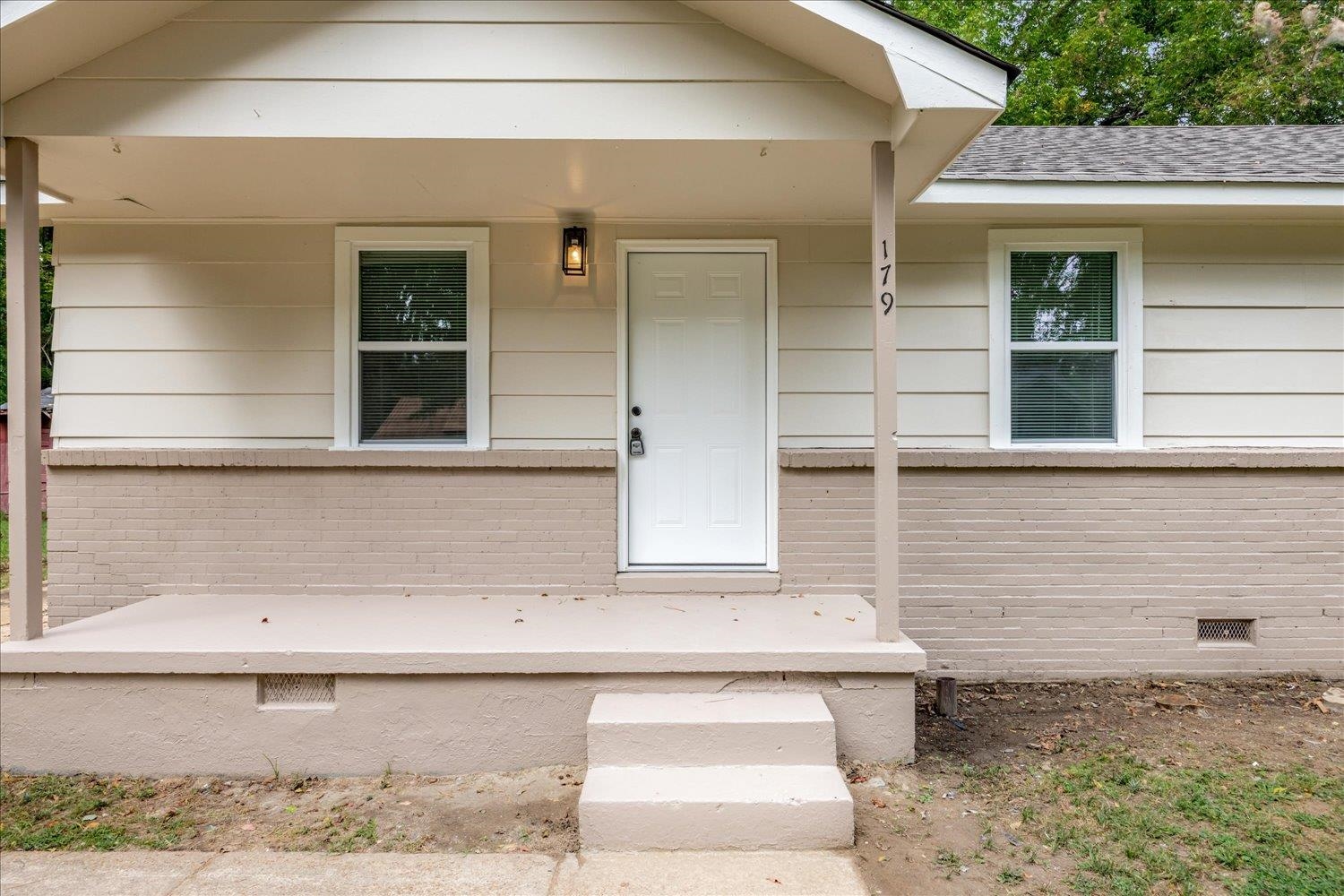 179 Harris Cove Collierville, TN 38017 - Photo 19 of 25 View of exterior entry with crawl space, a porch, brick siding, and a shingled roof