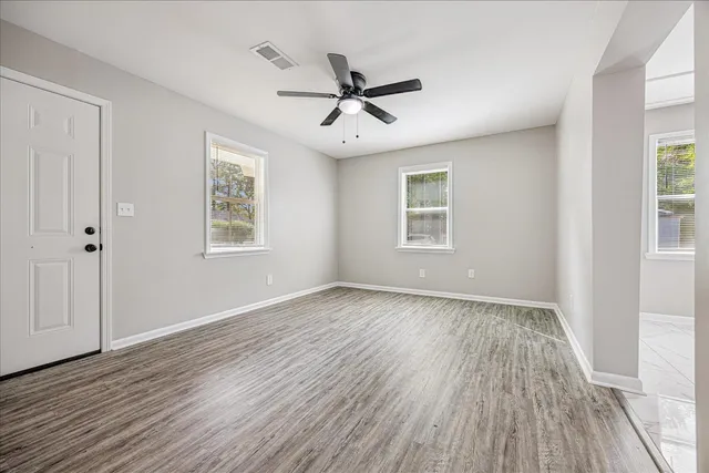 wooden floor in an empty room with a window