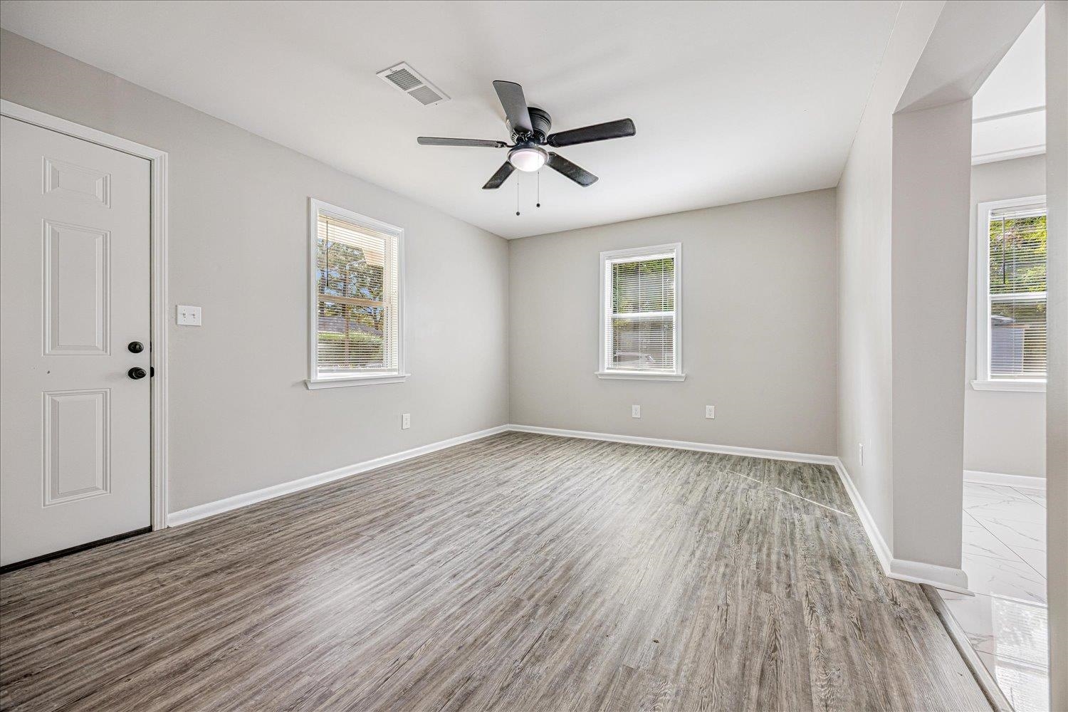179 Harris Cove Collierville, TN 38017 - Photo 5 of 25 Unfurnished room with wood finished floors and a ceiling fan