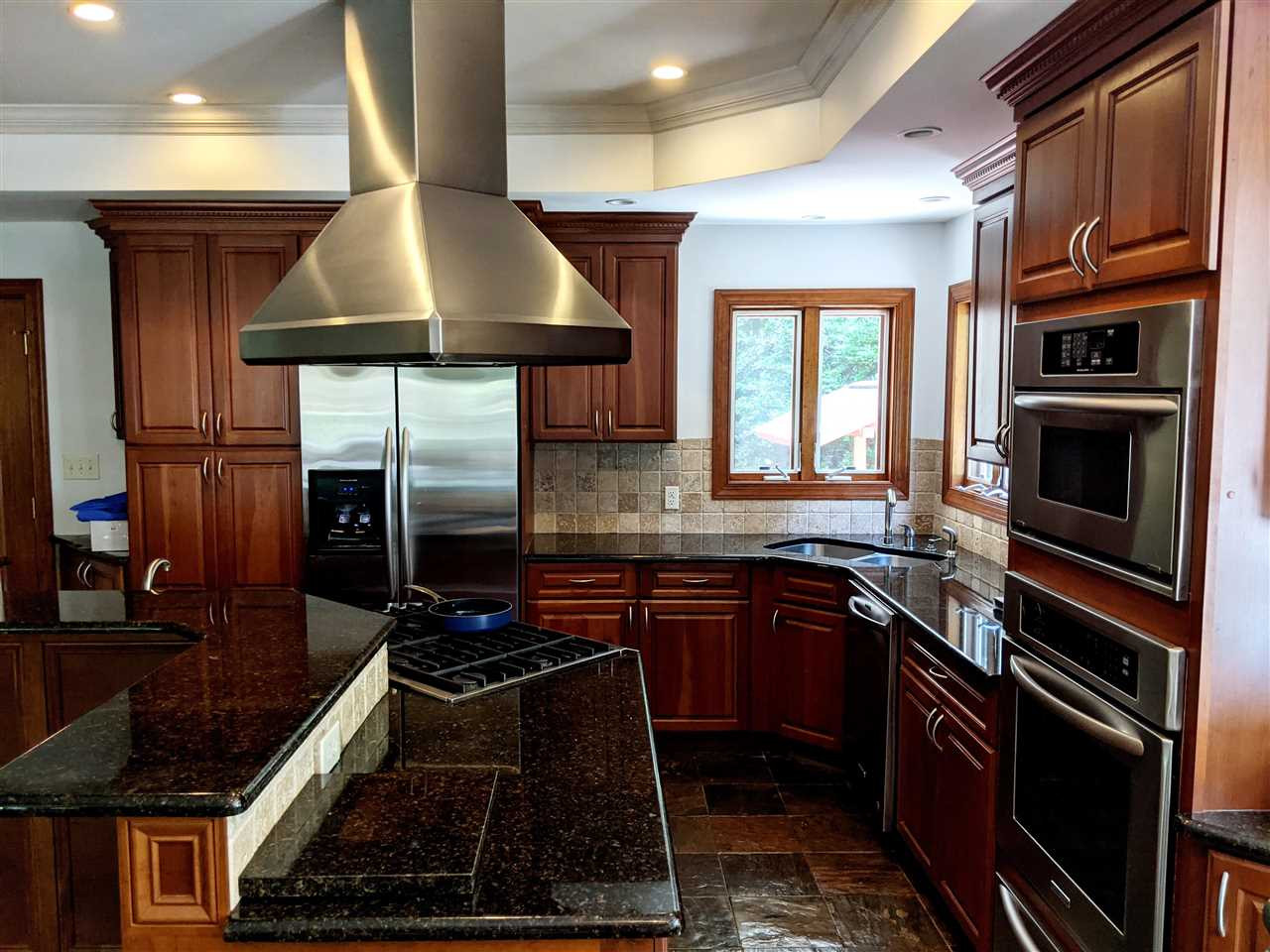 8529 Sawyer Drive Raleigh, NC 27613 - Photo 3 of 28 Completely updated kitchen. Open to dining & breakfast areas. Cherry cabinets, granite counters, 6 burner gas range, wall oven & microwave, overhead exhaust, heated & cooled slate floors, trey ceiling. Wow! Kitchen