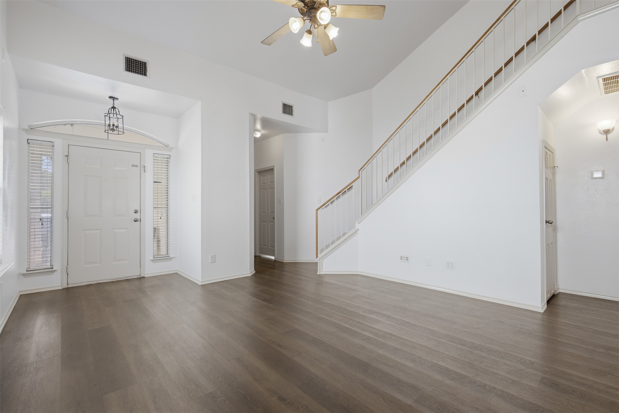 1416 Roxanne's Run Pflugerville, TX 78660 - Photo 7 of 35 A spacious entry and living area features rich wood flooring and a grand staircase.