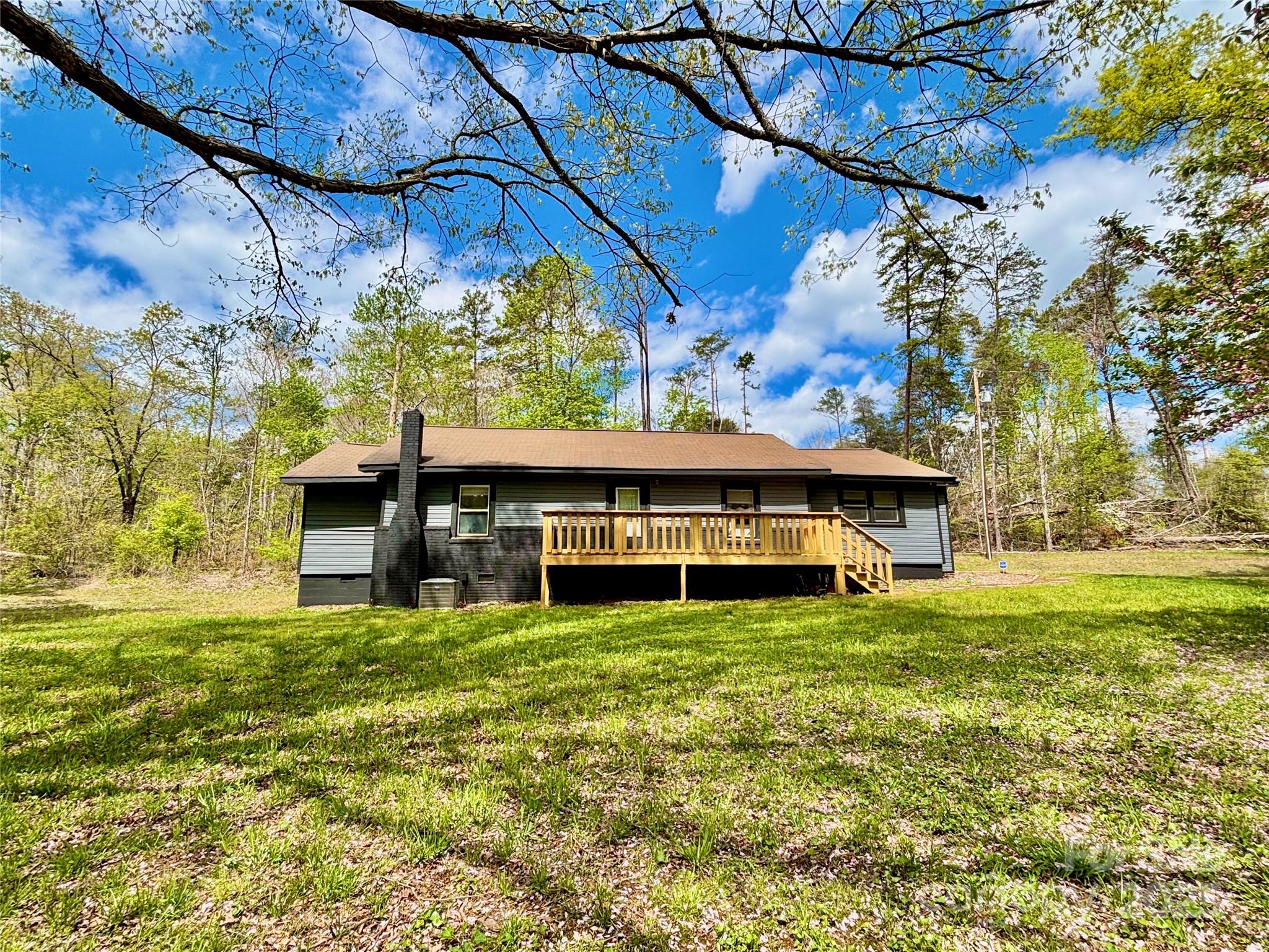 1180 Piney Ridge Road Forest City, NC 28043 - Photo 14 of 35 a view of a house with a big yard and large tree