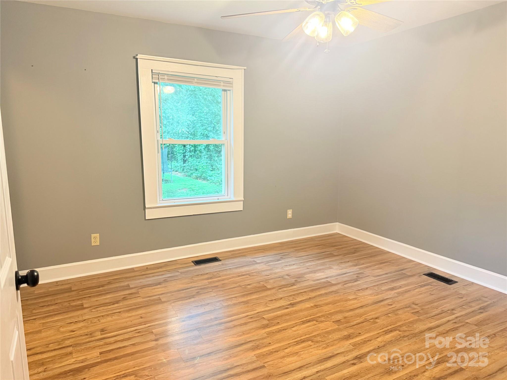 1180 Piney Ridge Road Forest City, NC 28043 - Photo 21 of 35 a view of an empty room with wooden floor and a window