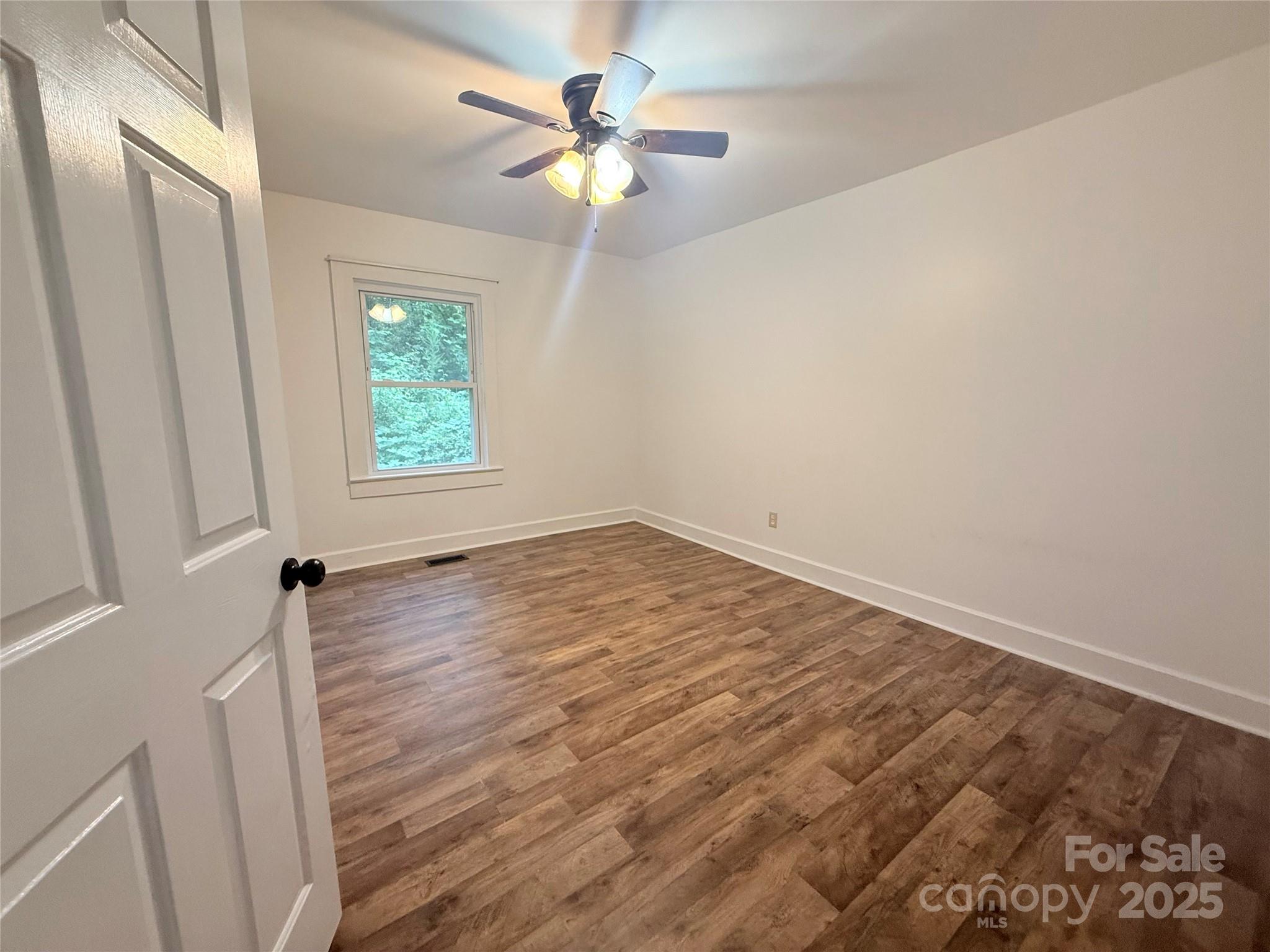 1180 Piney Ridge Road Forest City, NC 28043 - Photo 24 of 35 an empty room with a window and a fan