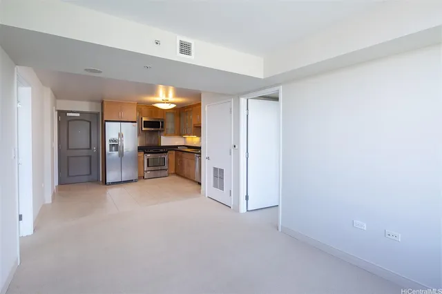 a view of a kitchen with a sink and a refrigerator