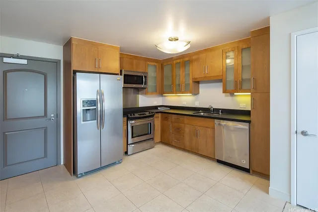 a kitchen with stainless steel appliances granite countertop a refrigerator and a sink